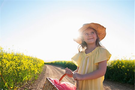 portrait looking away - Girl carrying basket on dirt road Stock Photo - Premium Royalty-Free, Code: 649-06489073
