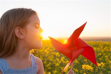 sun energy - Girl playing with pinwheel outdoors Stock Photo - Premium Royalty-Free, Code: 649-06489099