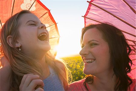 Mother and daughter holding parasols Stock Photo - Premium Royalty-Free, Code: 649-06489093