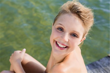 Woman smiling by still lake Stock Photo - Premium Royalty-Free, Code: 649-06489146