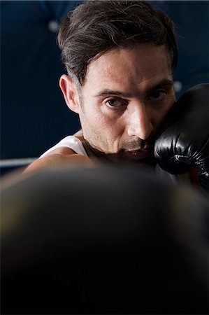 portrait of man at gym - Boxer with raised fists in ring Stock Photo - Premium Royalty-Free, Code: 649-06489205