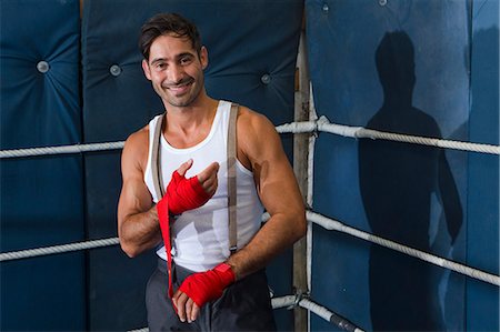 power smile - Boxer wrapping his wrists in ring Stock Photo - Premium Royalty-Free, Code: 649-06489210