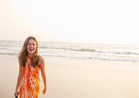 Smiling girl walking on beach Stock Photo - Premium Royalty-Free, Code: 649-06489243