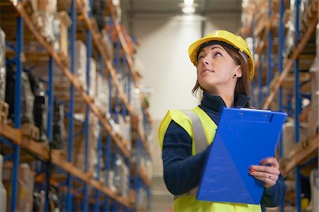 female hard hat - Worker checking stock in warehouse Stock Photo - Premium Royalty-Free, Code: 649-06489253