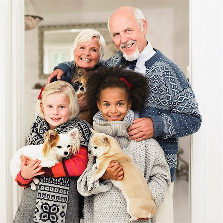 family looking at camera indoor - Family posing for Christmas picture Stock Photo - Premium Royalty-Free, Code: 649-06489283