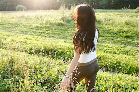 peaceful human - Woman walking in rural field Stock Photo - Premium Royalty-Free, Code: 649-06489426