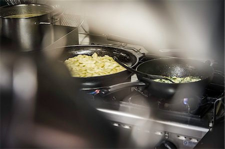 pan on stove - Pans of food cooking on stove Stock Photo - Premium Royalty-Free, Code: 649-06489678