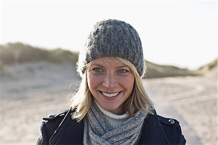 european adult beach photos - Smiling woman walking on beach Stock Photo - Premium Royalty-Free, Code: 649-06489705