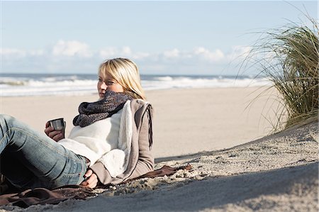 freedom not looking at camera horizontal - Woman drinking from thermos on beach Stock Photo - Premium Royalty-Free, Code: 649-06489708