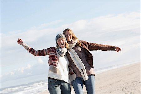 friends travel - Smiling women hugging on beach Stock Photo - Premium Royalty-Free, Code: 649-06489710