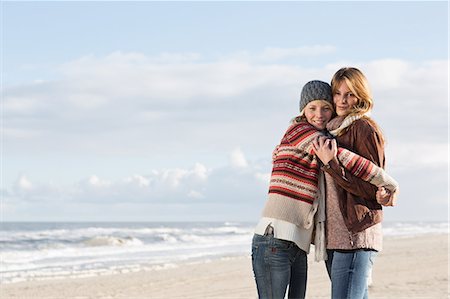 friends travel europe - Smiling women hugging on beach Stock Photo - Premium Royalty-Free, Code: 649-06489711