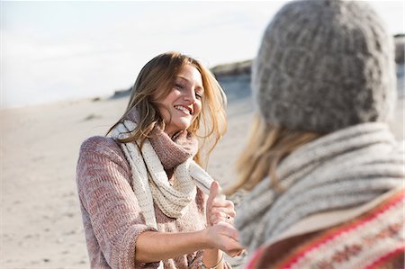 friends vacation in europe - Smiling women playing on beach Stock Photo - Premium Royalty-Free, Code: 649-06489723