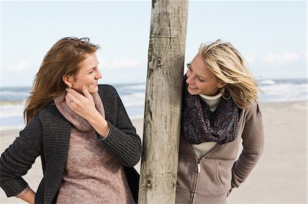 Smiling women talking on beach Stock Photo - Premium Royalty-Free, Code: 649-06489737