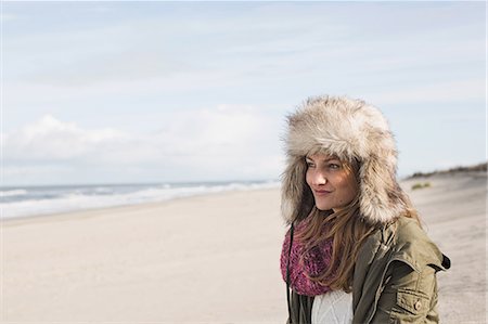 sea relaxation - Smiling woman standing on beach Stock Photo - Premium Royalty-Free, Code: 649-06489760