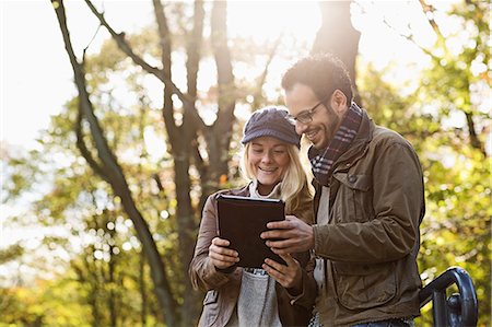 eyeglasses - Couple using tablet computer in forest Stock Photo - Premium Royalty-Free, Code: 649-06489778