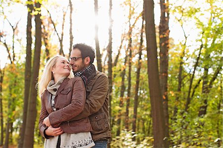 Smiling couple hugging in forest Stock Photo - Premium Royalty-Free, Code: 649-06489788