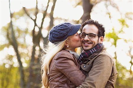 people in the park - Smiling couple kissing in forest Stock Photo - Premium Royalty-Free, Code: 649-06489781