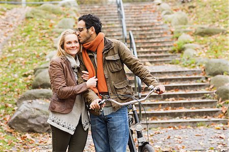 simsearch:6113-06721174,k - Couple walking bicycle in park Stock Photo - Premium Royalty-Free, Code: 649-06489799