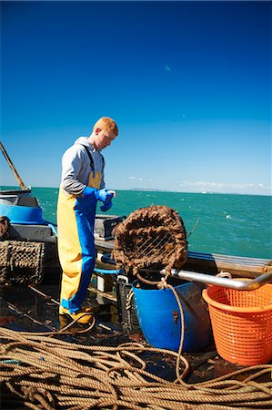 rubber gloves man - Fisherman at work on boat Stock Photo - Premium Royalty-Free, Code: 649-06489861