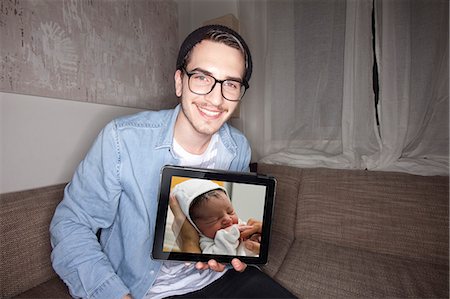 Man with newborn on tablet computer Photographie de stock - Premium Libres de Droits, Code: 649-06490083