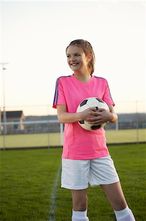 soccer player female standing - Football player holding ball in field Stock Photo - Premium Royalty-Free, Code: 649-06490147