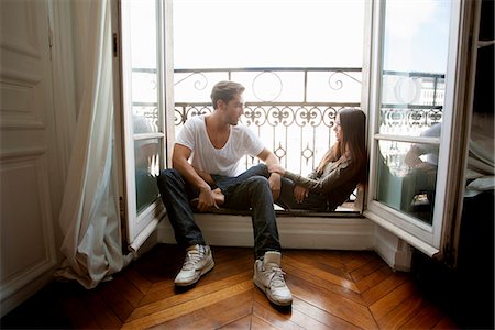 simsearch:649-06532541,k - Couple sitting in windowsill Stock Photo - Premium Royalty-Free, Code: 649-06532536