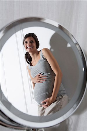 side mirror - Pregnant woman holding belly Stock Photo - Premium Royalty-Free, Code: 649-06532566