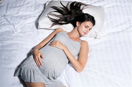 Pregnant woman sleeping in bed Stock Photo - Premium Royalty-Free, Code: 649-06532571