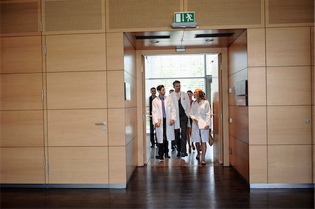 Doctors walking in office hallway Stock Photo - Premium Royalty-Free, Code: 649-06532629