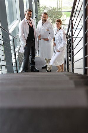 doctor standing full body - Doctors talking on staircase in office Stock Photo - Premium Royalty-Free, Code: 649-06532645