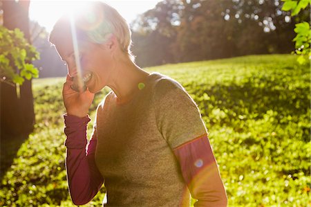 Woman talking on cell phone in park Stock Photo - Premium Royalty-Free, Code: 649-06532676