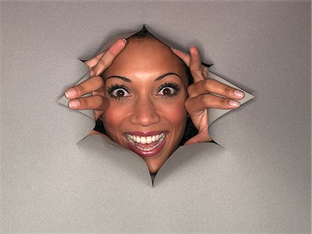 Woman pushing through hole in wall Photographie de stock - Premium Libres de Droits, Code: 649-06532755