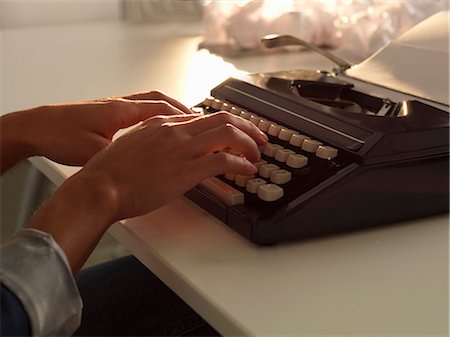 Close up of woman using typewriter Stock Photo - Premium Royalty-Free, Code: 649-06532751