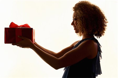 dar - Woman holding wrapped gift Foto de stock - Sin royalties Premium, Código: 649-06532785