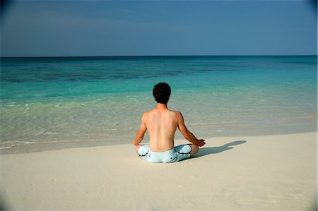 sitting yoga pose outside - Man meditating on tropical beach Stock Photo - Premium Royalty-Free, Code: 649-06532949