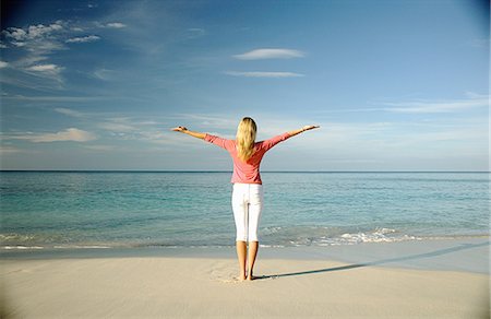 paradise island bahamas beach - Woman standing on tropical beach Stock Photo - Premium Royalty-Free, Code: 649-06532954