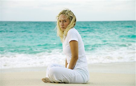 paradise island bahamas beach - Woman sitting on tropical beach Stock Photo - Premium Royalty-Free, Code: 649-06532957