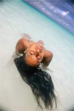 paradise island bahamas beach - Woman floating in tropical water Stock Photo - Premium Royalty-Free, Code: 649-06532996