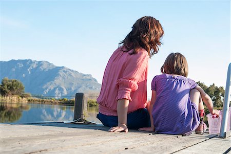 family back view - Mother and daughter sitting on deck Stock Photo - Premium Royalty-Free, Code: 649-06533018