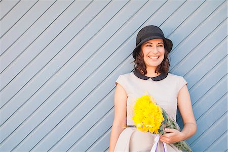 pictures of bouquet - Woman leaning on wooden wall outdoors Stock Photo - Premium Royalty-Free, Code: 649-06533045