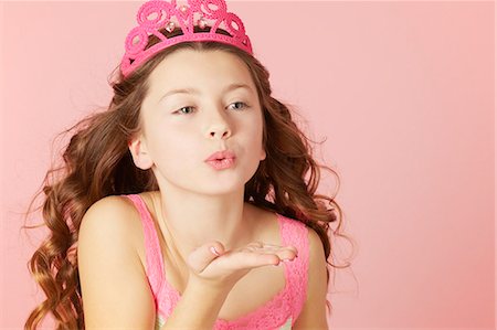 Girl in pink tiara blowing kisses Foto de stock - Sin royalties Premium, Código: 649-06533067