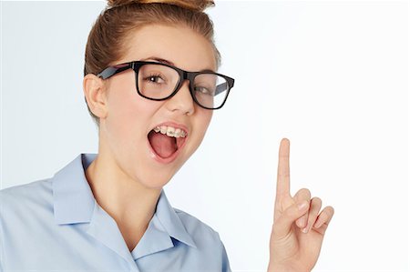 preteen girl arms raised - Close up of smiling girl in braces Stock Photo - Premium Royalty-Free, Code: 649-06533075