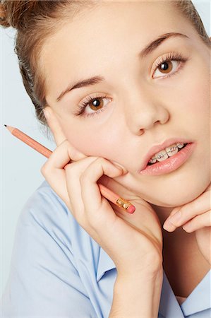 Frustrated girl holding chin in hands Fotografie stock - Premium Royalty-Free, Codice: 649-06533078