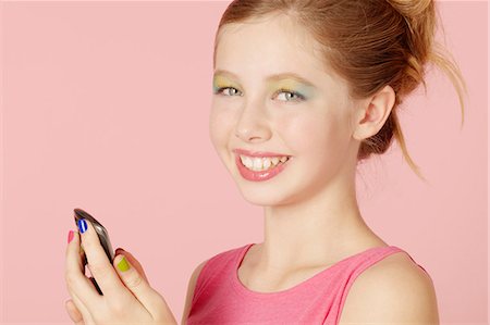 simsearch:649-03774177,k - Girl in colorful makeup using cell phone Photographie de stock - Premium Libres de Droits, Code: 649-06533098