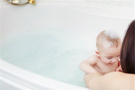 Mother washing baby girl in bubble bath Foto de stock - Sin royalties Premium, Código: 649-06533126