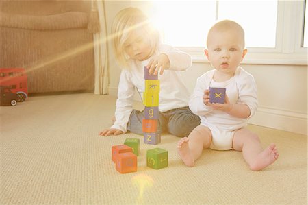 Children playing with toys on floor Stock Photo - Premium Royalty-Free, Code: 649-06533143