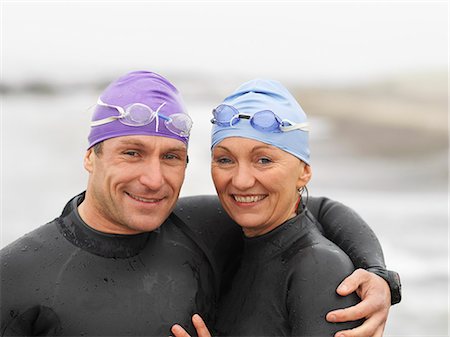 Divers smiling together on beach Stock Photo - Premium Royalty-Free, Code: 649-06533156