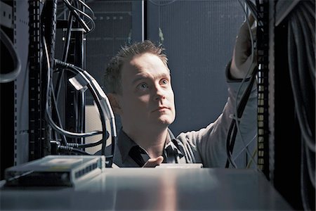 simsearch:6113-06721341,k - Man working in server room Stock Photo - Premium Royalty-Free, Code: 649-06533296