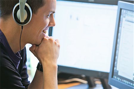 Man using computers at desk Stock Photo - Premium Royalty-Free, Code: 649-06533311