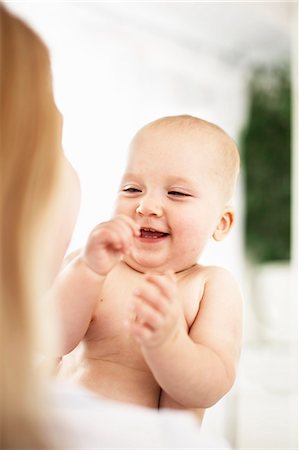 Mother holding laughing baby girl Photographie de stock - Premium Libres de Droits, Code: 649-06533382